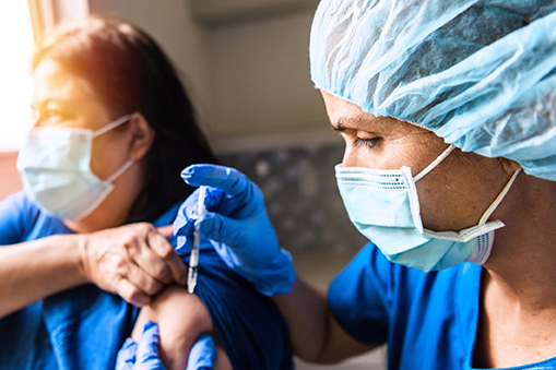 A woman receiving a vaccination