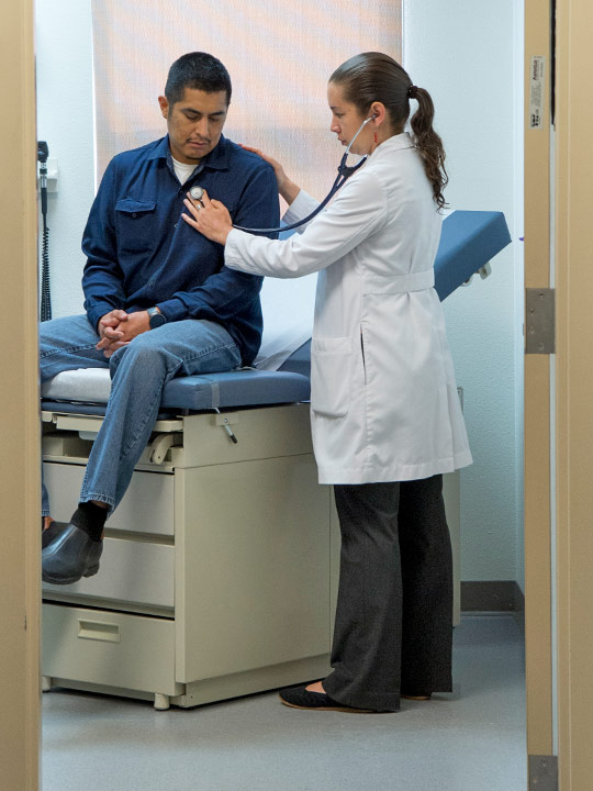 Male patient being examined by a female medical staff