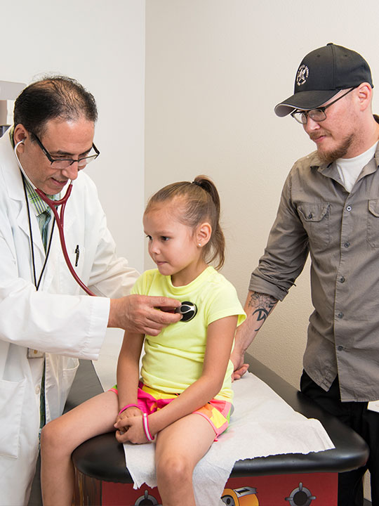 Female patient and father with a male medical staff