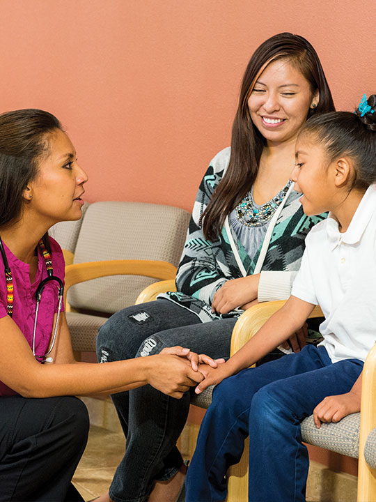 Mother and daughter with a female medical staff