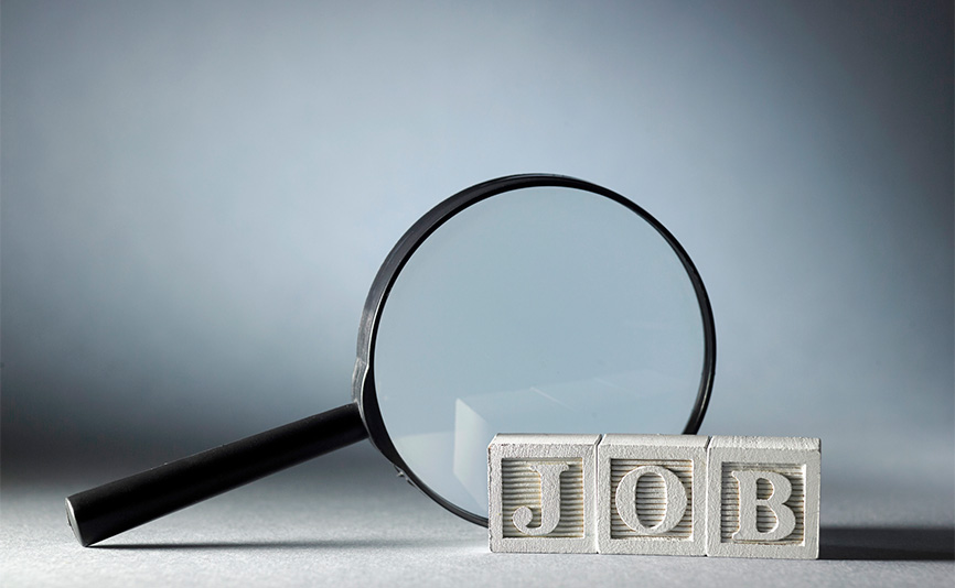 A magnifying glass next to block letters spelling the word Job.