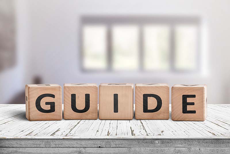 wooden blocks with the word Guide spelled out.