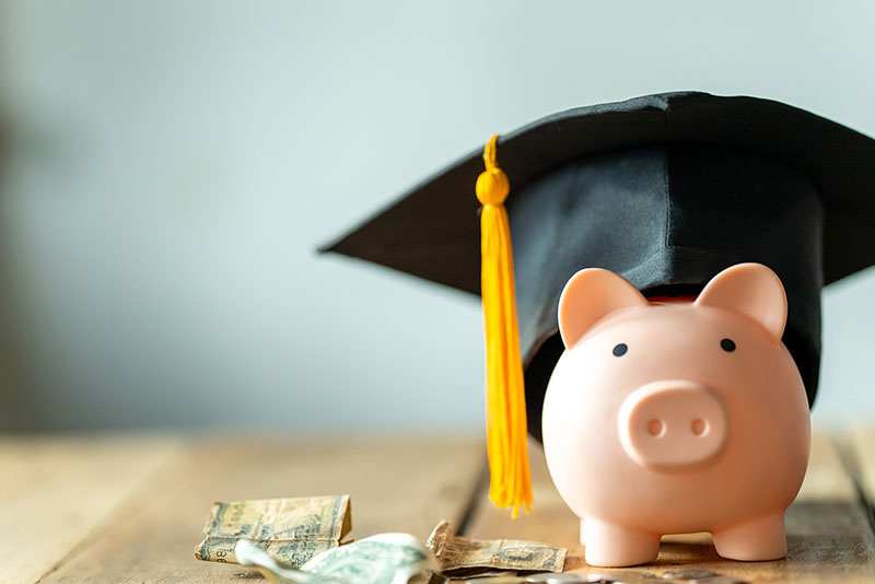 a piggybank with a graduation cap on it