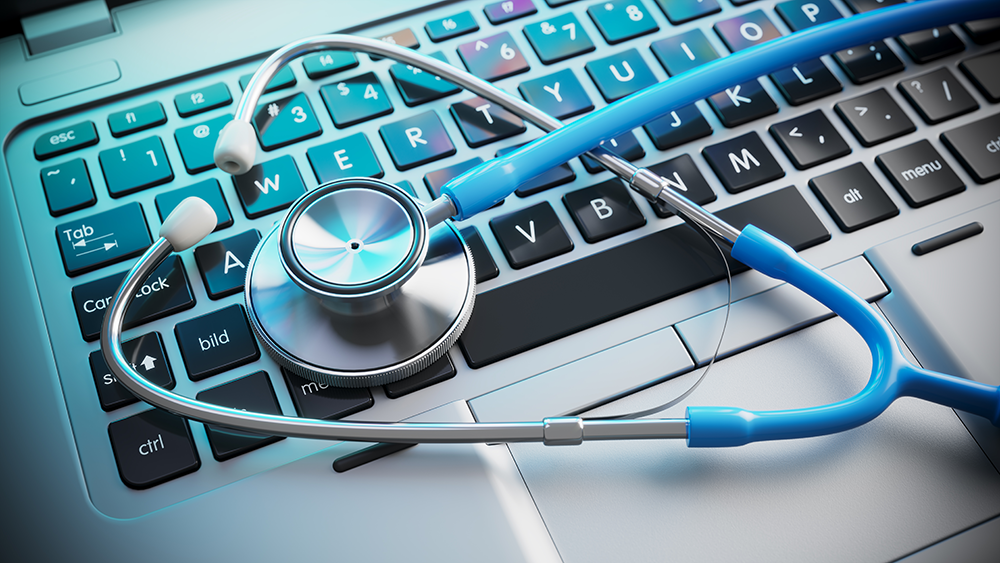 A stethescope resting on top of a computer keyboard.