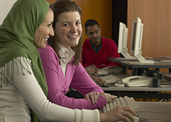 Two young women in a computer lab.