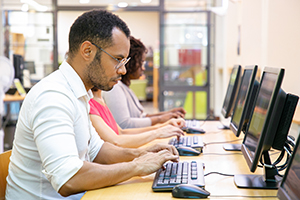 Man at computer terminal.