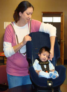 Conducting a car seat safety inspection.