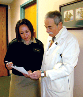 Two doctors talk in a hallway