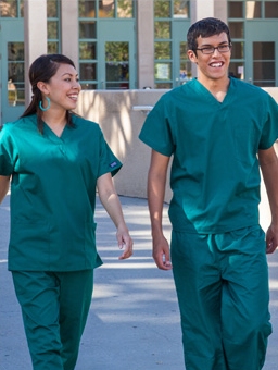 Two medical professions walking together while having a discussion
