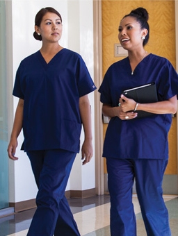 Two woman nurses walking while having a discussion