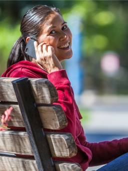 Woman smiles while talking on the cell phone.