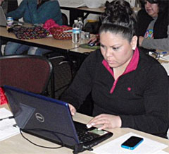 Student at computer typing her digital story script.