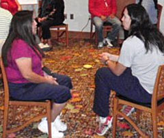 Two women participating in a story circle. Two women participating in a story circle.