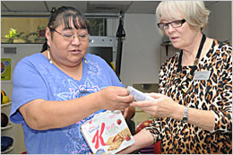 Two women at the Denver Indian Health and Family Services discussing how to lose weight and practice diabetes self care.