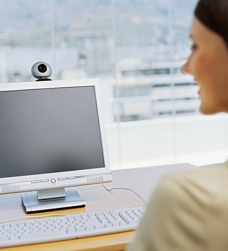 A woman looking at a teleeducation presentation