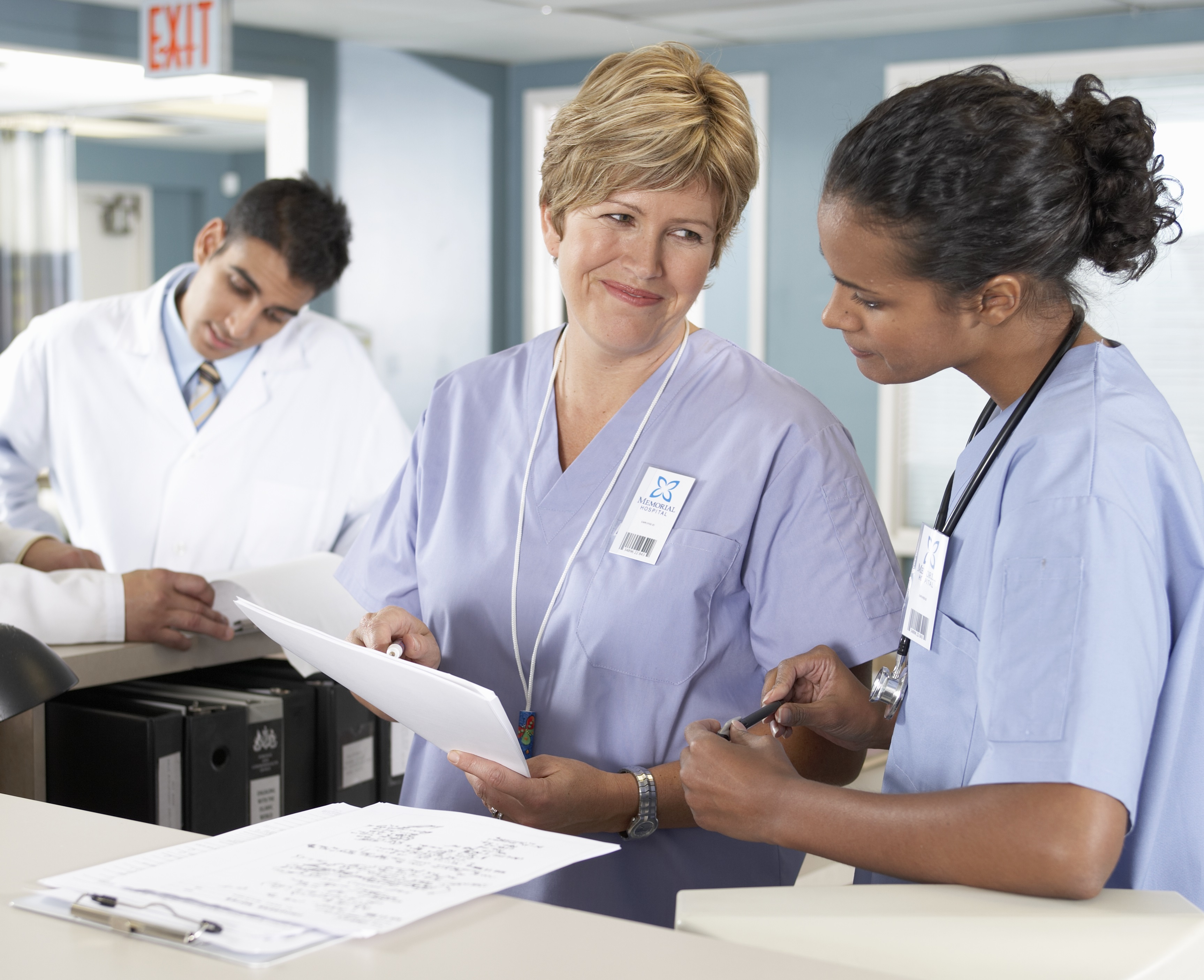 Doctors looking at a clipboard