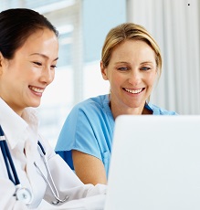 Two doctors using a laptop