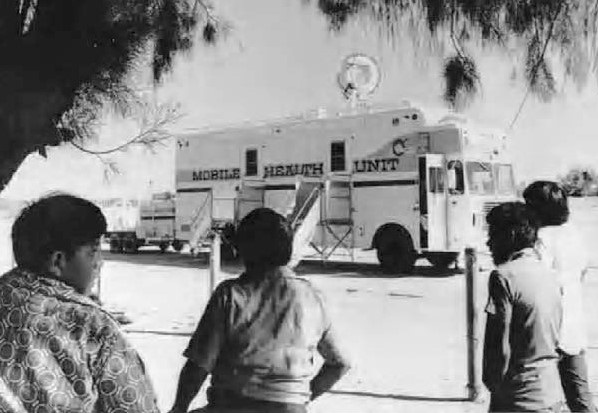Native children looking at a telehealth satelite truck in 1973