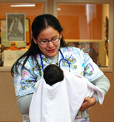healthcare worker holding a newborn